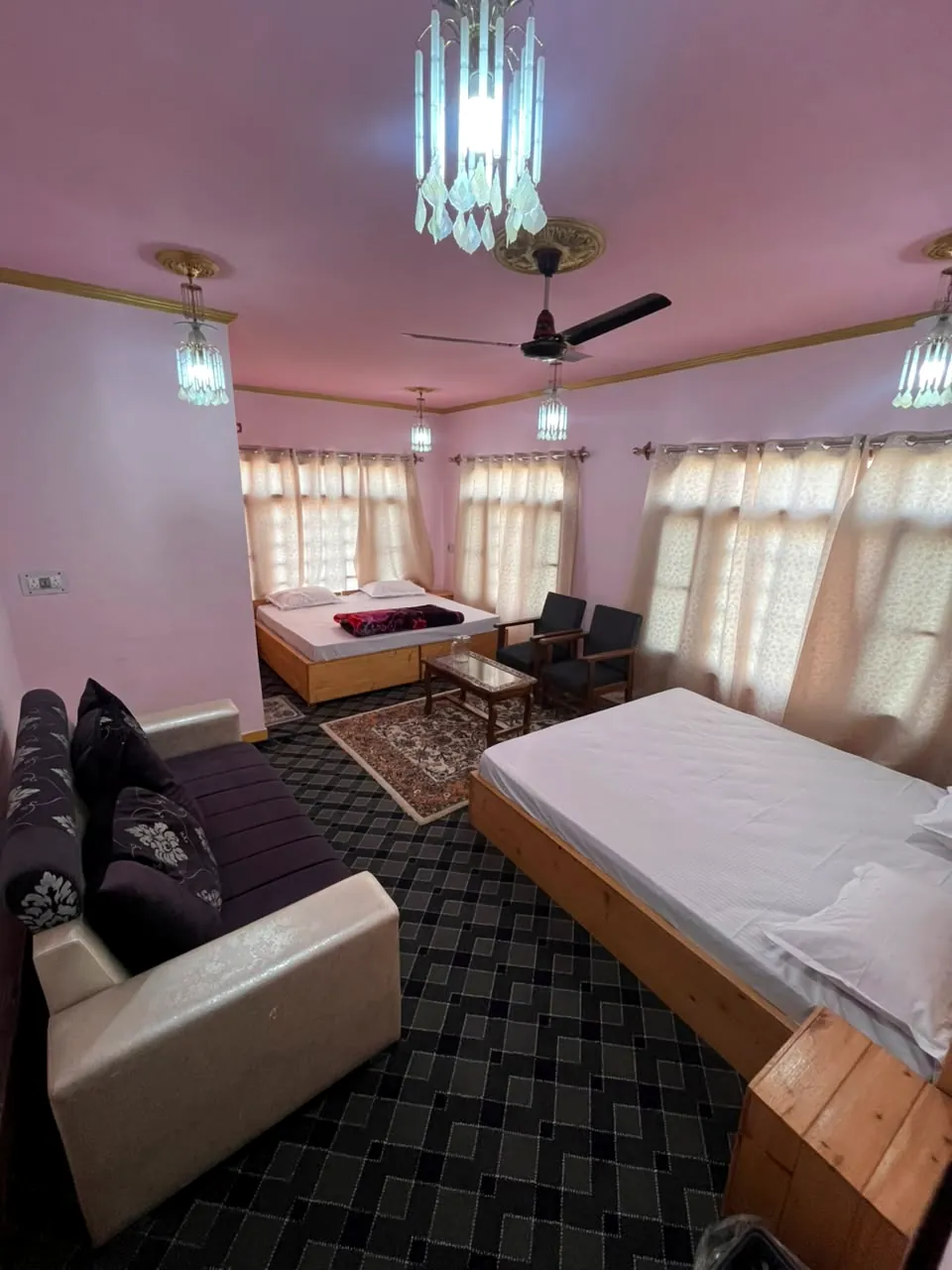 Capella room — a wide bright suite with two beds and a sitting corner